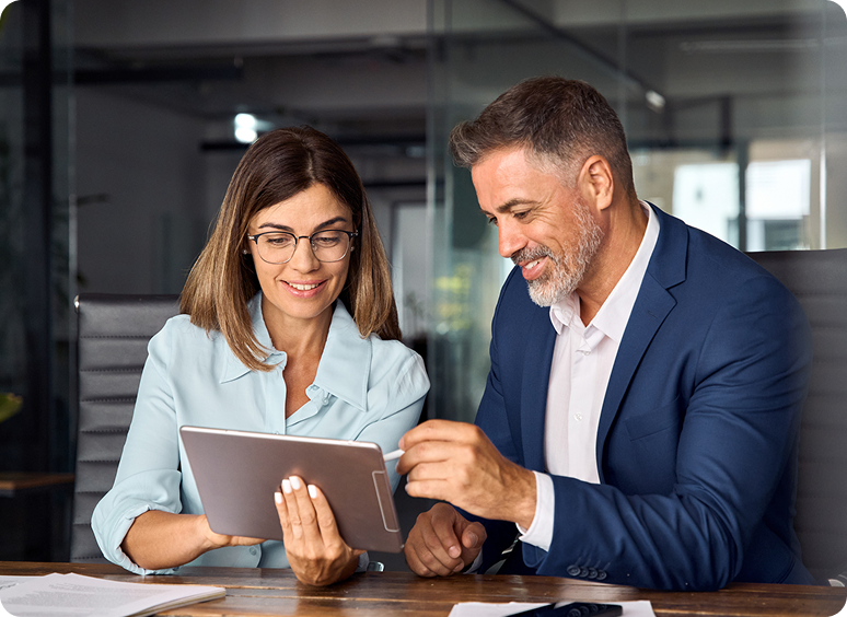Business meeting with two people using tablet.