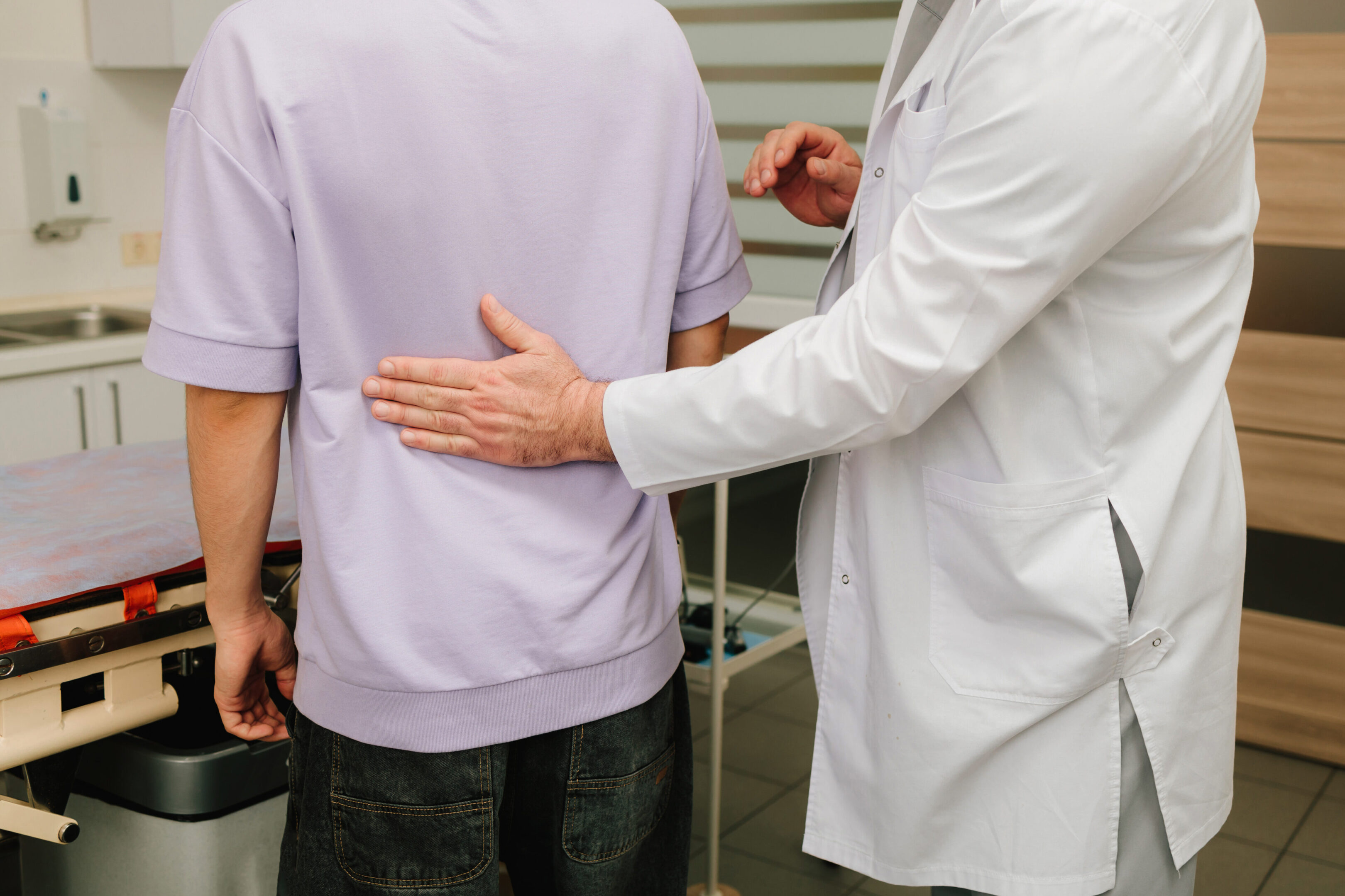Physical exam with urologist performing renal percussion for kidney pain